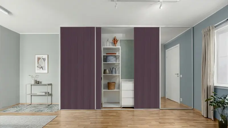 Sliding wardrobe with dark violet fluted laminate sheet adding a bold textured design to a modern interior space