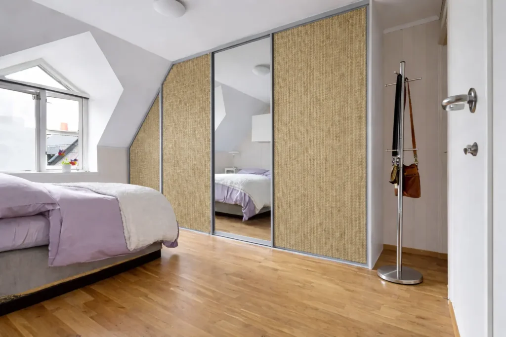 Sliding door wardrobe with honey oak brown fabric laminate sheet finish creating a warm and elegant modern bedroom interior