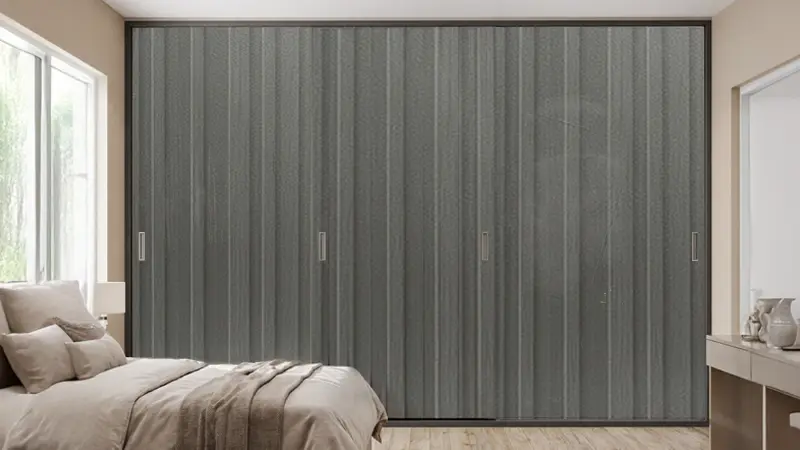 Sliding wardrobe with smoky grey woodgrain laminate sheet finish creating a stylish and modern bedroom interior
