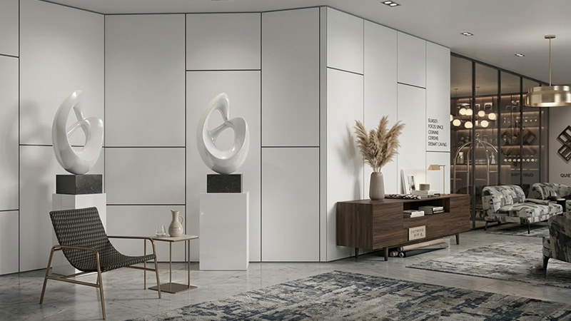 Modern hotel lobby lounge featuring durable white high pressure laminate wall cladding with dark accent grooves and art sculptures.