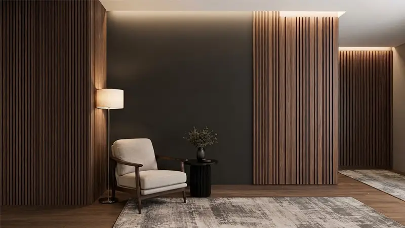 Modern living room featuring dark wooden fluted louver wall panelling, accent lighting, and a beige armchair.